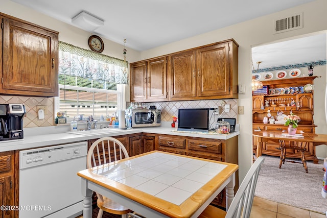 530B Sheffield Dr, Manchester, NJ 08759 - kitchen featuring dishwasher, stainless steel microwave, backsplash, and tile countertops