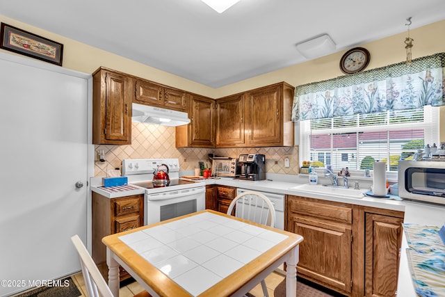 530B Sheffield Dr, Manchester, NJ 08759 - kitchen featuring white appliances, under cabinet range hood, brown cabinets, backsplash, and light countertops