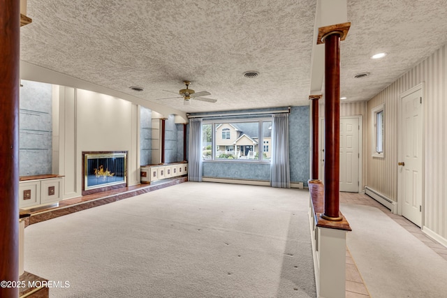 811 Fay Ct, Point Pleasant, NJ 08742 - unfurnished living room featuring a ceiling fan, a baseboard radiator, a glass covered fireplace, a textured ceiling, and recessed lighting
