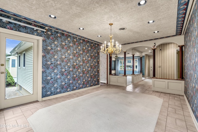811 Fay Ct, Point Pleasant, NJ 08742 - unfurnished dining area with a chandelier, wallpapered walls, a textured ceiling, baseboard heating, and arched walkways