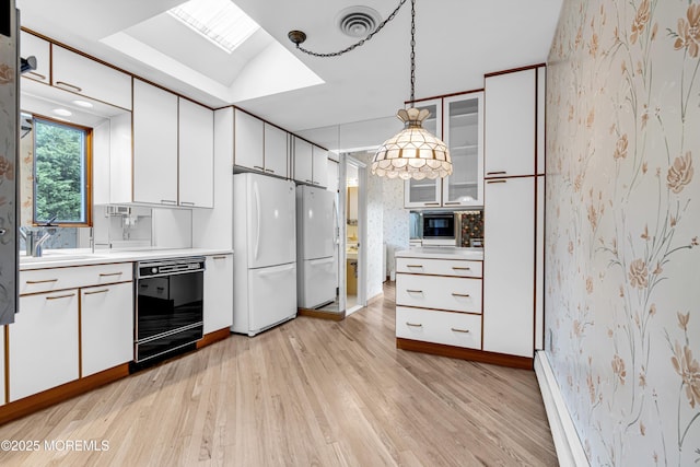 811 Fay Ct, Point Pleasant, NJ 08742 - kitchen with black dishwasher, freestanding refrigerator, light countertops, light wood-style flooring, and wallpapered walls