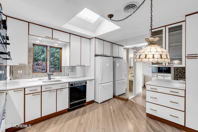 811 Fay Ct, Point Pleasant, NJ 08742 - kitchen with black dishwasher, freestanding refrigerator, white cabinetry, and light countertops