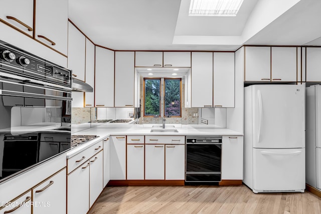 811 Fay Ct, Point Pleasant, NJ 08742 - kitchen with black appliances, white cabinetry, light countertops, and light wood finished floors