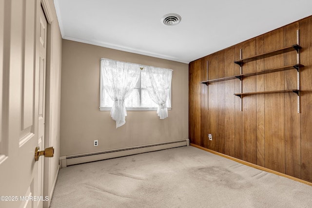 811 Fay Ct, Point Pleasant, NJ 08742 - empty room with a baseboard heating unit, carpet flooring, crown molding, and wooden walls