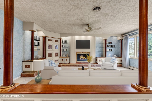 811 Fay Ct, Point Pleasant, NJ 08742 - living room featuring ceiling fan, a glass covered fireplace, and a textured ceiling