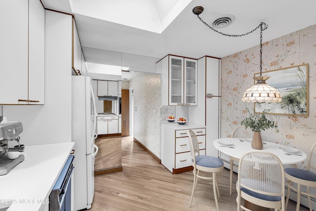 811 Fay Ct, Point Pleasant, NJ 08742 - kitchen with wallpapered walls, freestanding refrigerator, light wood finished floors, a baseboard radiator, and light countertops