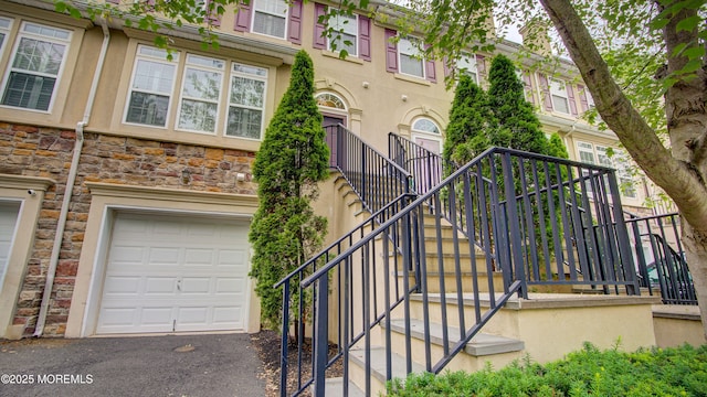 56 W Aspen Way, Aberdeen, NJ 07747 - exterior space with a garage, stucco siding, and stone siding