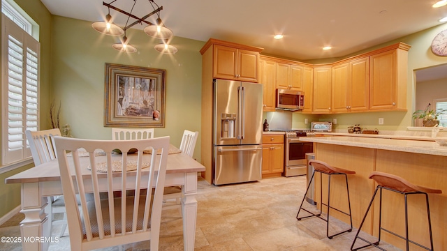 56 W Aspen Way, Aberdeen, NJ 07747 - kitchen with appliances with stainless steel finishes, light countertops, a breakfast bar area, recessed lighting, and light brown cabinets