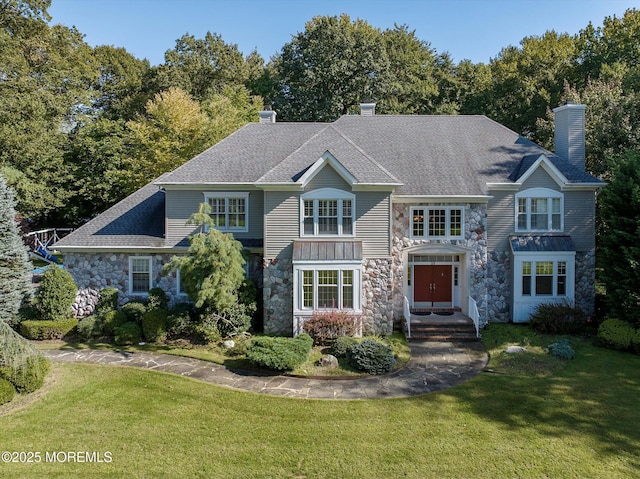 26 Bruns Rd, Allenhurst, NJ 07711 - view of front facade featuring stone siding, a chimney, and a front lawn