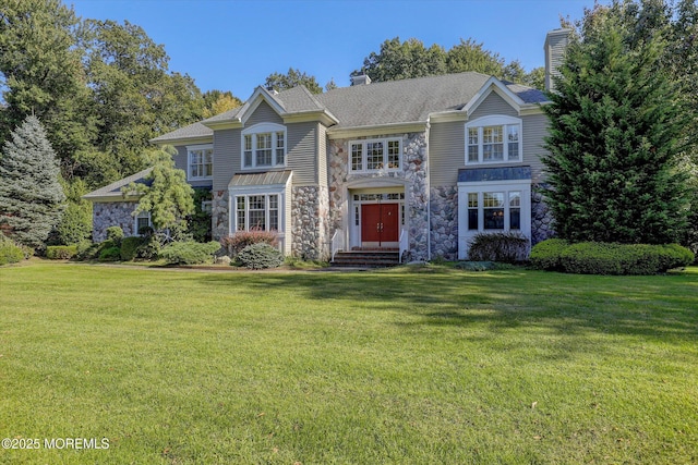 26 Bruns Rd, Allenhurst, NJ 07711 - view of front of home with stone siding, a chimney, and a front lawn
