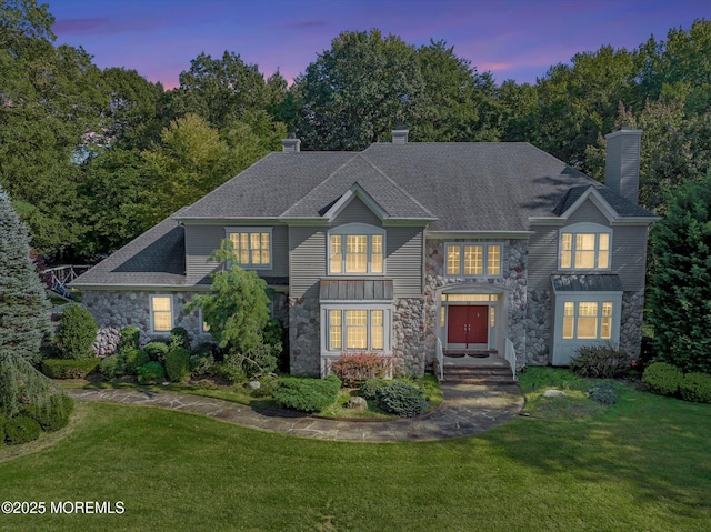 26 Bruns Rd, Allenhurst, NJ 07711 - view of front of property featuring stone siding, a chimney, and a front yard