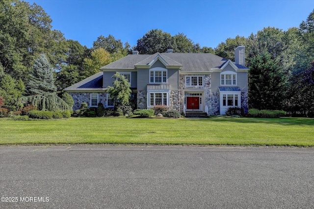 26 Bruns Rd, Allenhurst, NJ 07711 - view of front of home with stone siding, a front yard, and a chimney