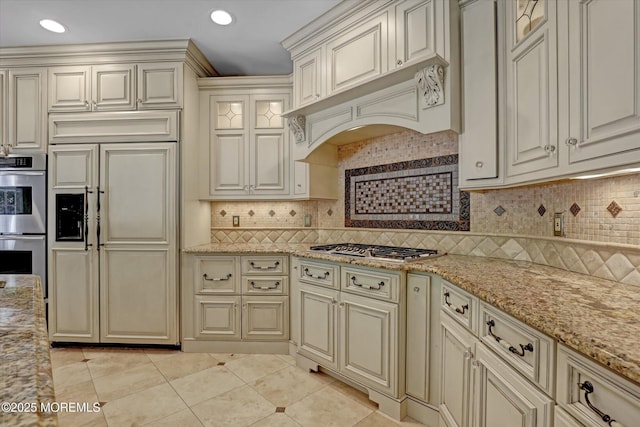 26 Bruns Rd, Allenhurst, NJ 07711 - kitchen with appliances with stainless steel finishes, cream cabinets, light tile patterned floors, backsplash, and light stone countertops