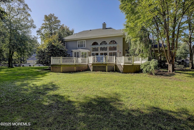 26 Bruns Rd, Allenhurst, NJ 07711 - rear view of house featuring a wooden deck, a lawn, and a chimney