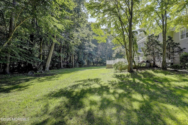 26 Bruns Rd, Allenhurst, NJ 07711 - view of grassy yard featuring a deck