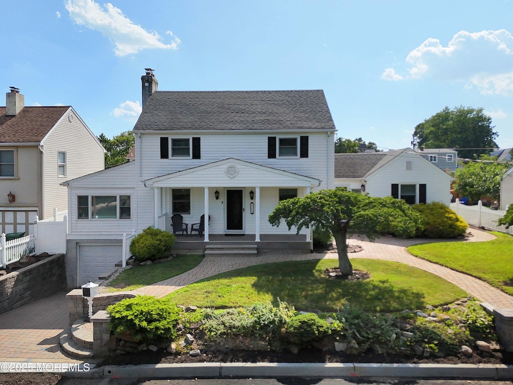 222 Morgan Ave, Sayreville, NJ 08879 - view of front of house featuring a porch, decorative driveway, an attached garage, and a chimney