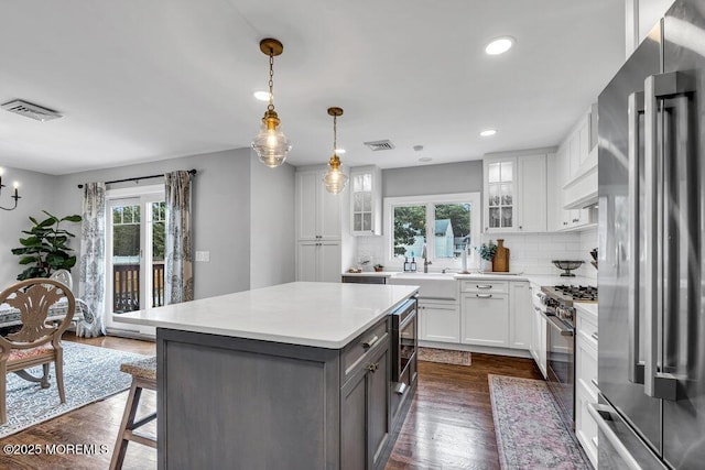 17 Rose St, Lincroft, NJ 07738 - kitchen with high quality appliances, healthy amount of natural light, white cabinets, decorative backsplash, and recessed lighting