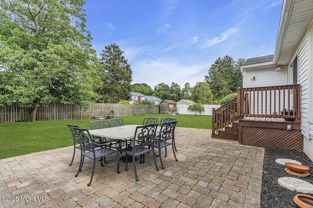 17 Rose St, Lincroft, NJ 07738 - fenced backyard featuring outdoor dining area, a storage unit, a patio area, and a wooden deck