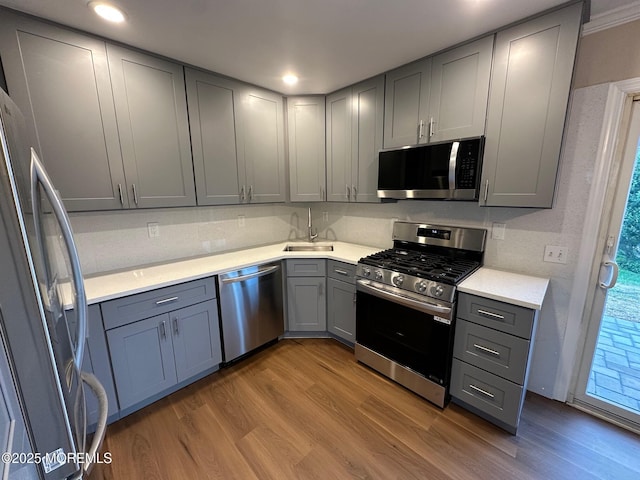 8 Missouri Ct, Matawan, NJ 07747 - kitchen with appliances with stainless steel finishes, gray cabinets, wood finished floors, light countertops, and recessed lighting