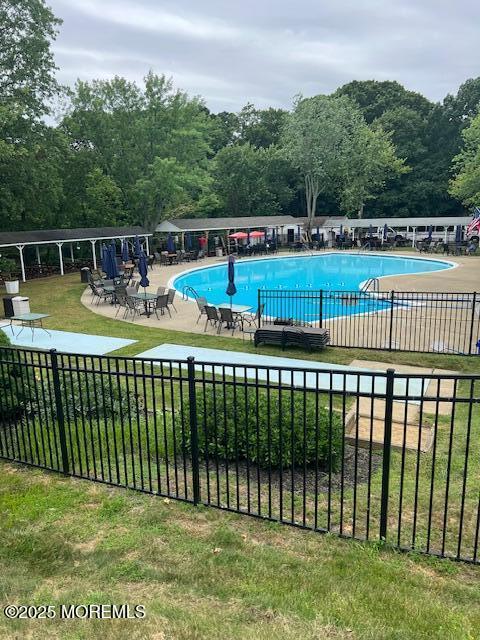 8 Missouri Ct, Matawan, NJ 07747 - community pool featuring a patio area and a wooded view