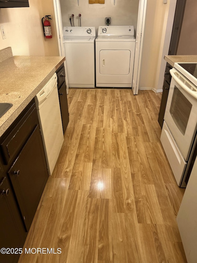 71 Overlook Way Unit H, Manalapan, NJ 07726 - kitchen with stove, dishwasher, light wood-style flooring, light countertops, and washer and clothes dryer