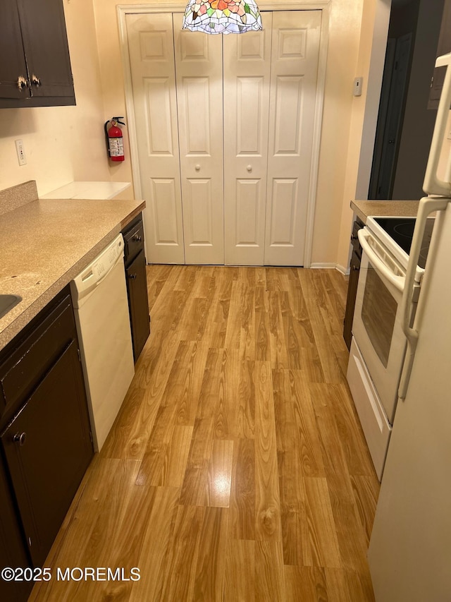 71 Overlook Way Unit H, Manalapan, NJ 07726 - kitchen featuring white dishwasher, light wood finished floors, range, and light countertops