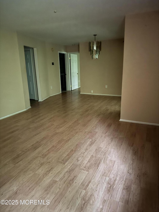 71 Overlook Way Unit H, Manalapan, NJ 07726 - spare room featuring wood finished floors and a chandelier