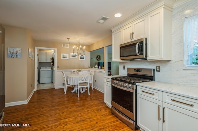 12 Aarons Way, Brick, NJ 08723 - kitchen with stainless steel appliances, washer / clothes dryer, a chandelier, dark wood-style flooring, and white cabinets