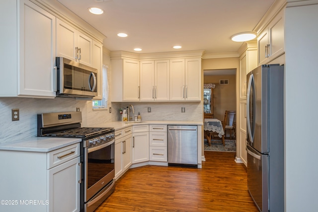 12 Aarons Way, Brick, NJ 08723 - kitchen with appliances with stainless steel finishes, light countertops, dark wood finished floors, decorative backsplash, and white cabinets