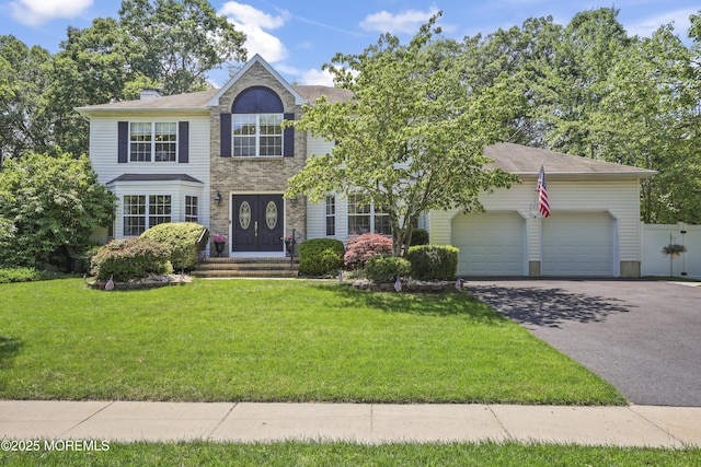 304 Mackenzie Dr, Jackson, NJ 08527 - view of front of property featuring asphalt driveway, a garage, and a chimney