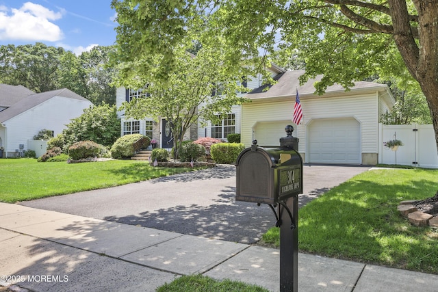 304 Mackenzie Dr, Jackson, NJ 08527 - view of front facade featuring driveway, a garage, and a gate