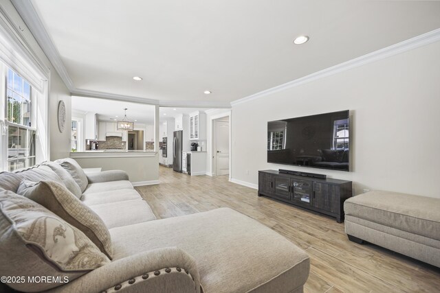 304 Mackenzie Dr, Jackson, NJ 08527 - living room featuring ornamental molding, light wood-style floors, recessed lighting, and a chandelier