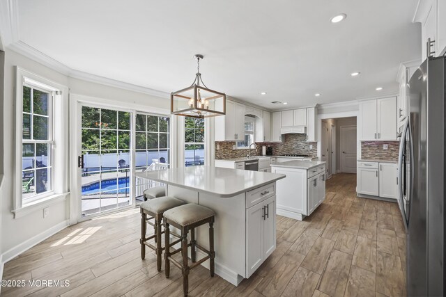 304 Mackenzie Dr, Jackson, NJ 08527 - kitchen featuring stainless steel appliances, a center island, plenty of natural light, crown molding, and recessed lighting
