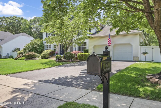 304 Mackenzie Dr, Jackson, NJ 08527 - view of front facade featuring driveway, a garage, and a gate