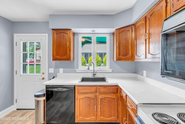 14A Portsmouth St, Whiting, NJ 08759 - kitchen with dishwasher, oven, light countertops, brown cabinetry, and light wood finished floors