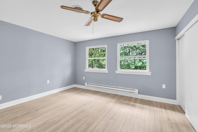 14A Portsmouth St, Whiting, NJ 08759 - unfurnished room with a baseboard heating unit, a ceiling fan, and light wood-style flooring