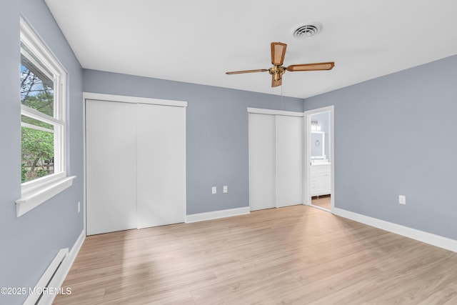 14A Portsmouth St, Whiting, NJ 08759 - unfurnished bedroom featuring two closets, wood finished floors, a baseboard radiator, connected bathroom, and a ceiling fan