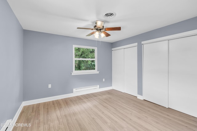 14A Portsmouth St, Whiting, NJ 08759 - unfurnished bedroom with a baseboard heating unit, multiple closets, wood finished floors, and a ceiling fan