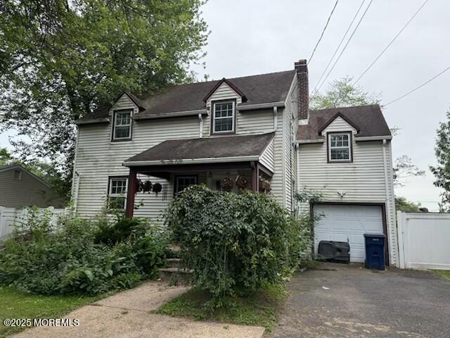 59 1st St, Fanwood, NJ 07023 - view of front facade featuring driveway, a chimney, and an attached garage
