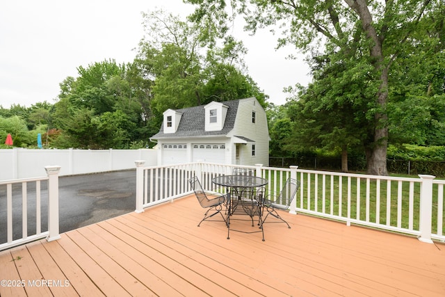 35 Fairview Dr, Middletown, NJ 07748 - wooden terrace featuring an outdoor structure, outdoor dining space, view of wooded area, and a garage