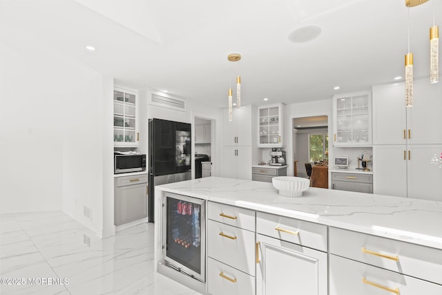 1218 W Park Ave, Ocean Twp, NJ 07712 - kitchen with beverage cooler, stainless steel microwave, refrigerator, light marble finish flooring, and white cabinets