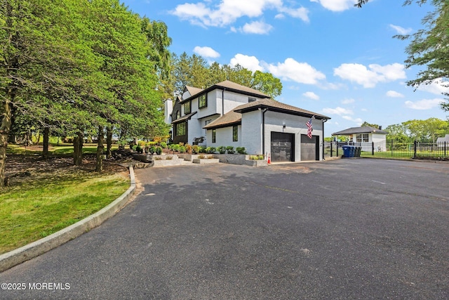1218 W Park Ave, Ocean Twp, NJ 07712 - view of front of house with driveway, an attached garage, and stucco siding