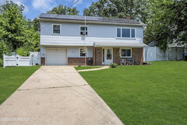 886 Stafford Dr, Toms River, NJ 08753 - view of front facade with brick siding, solar panels, a garage, and driveway