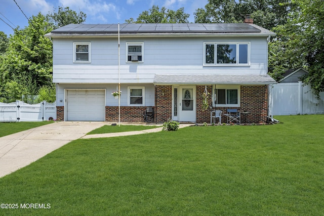 886 Stafford Dr, Toms River, NJ 08753 - view of front of property featuring brick siding, roof mounted solar panels, an attached garage, and driveway