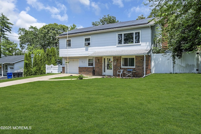 886 Stafford Dr, Toms River, NJ 08753 - view of front of property featuring driveway, a garage, solar panels, and brick siding