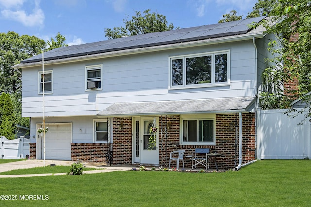 886 Stafford Dr, Toms River, NJ 08753 - view of front of home with brick siding, an attached garage, and solar panels