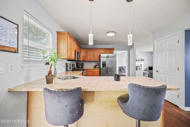 18 4th Ave, Toms River, NJ 08757 - kitchen with appliances with stainless steel finishes, light countertops, a peninsula, dark wood finished floors, and a breakfast bar area