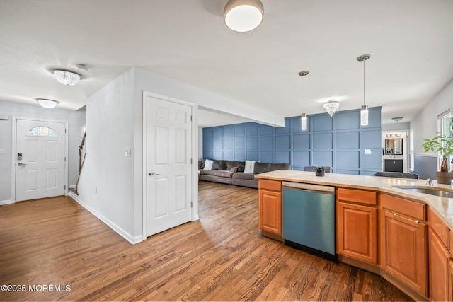 18 4th Ave, Toms River, NJ 08757 - kitchen featuring dishwasher, open floor plan, wood finished floors, light countertops, and decorative light fixtures