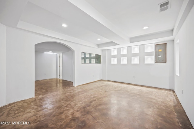 18 4th Ave, Toms River, NJ 08757 - unfurnished room with electric panel, a tray ceiling, concrete floors, arched walkways, and recessed lighting