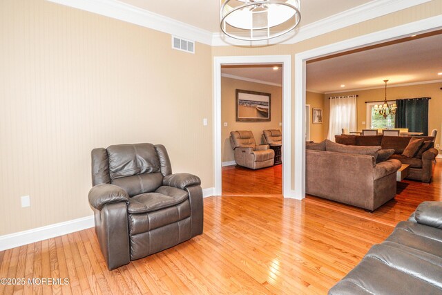 45 Sugar Hill Rd, Manahawkin, NJ 08050 - living room with a chandelier, light wood-style flooring, and crown molding